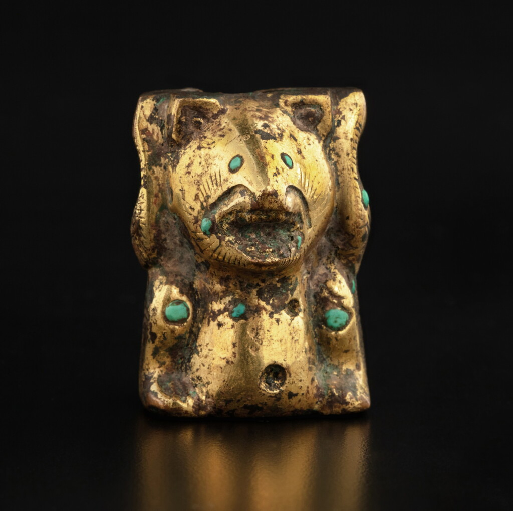 View full screen - View 1 of Lot 43. A turquoise-inlaid gilt-bronze 'bear' fitting, Han dynasty | 漢 銅鎏金嵌綠松石熊形承足.