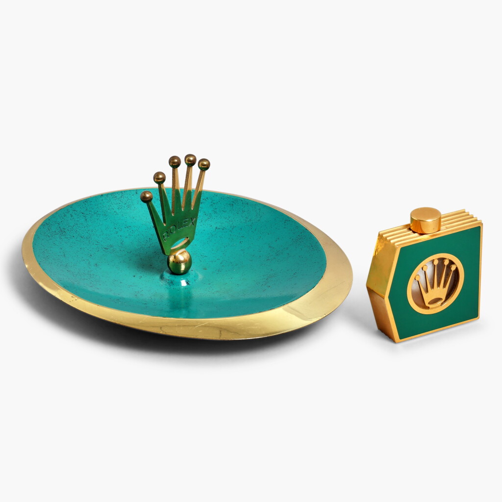 View full screen - View 1 of Lot 303. A group of accessories comprising a brass painted ashtray and an enameled brass and crystal perfume bottle, Circa 1980s.