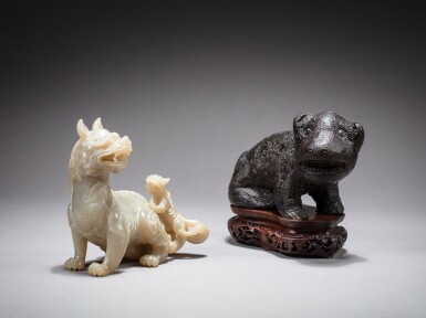View full screen - View 1 of Lot 40. An inscribed black lacquered stoneware archaistic bear and a carved jade 'bixie'; The inscribed archaistic ceramic bear: Qing dynasty - Republican period, The bixie: 20th century | 二十世紀 青玉童子辟邪把件 及 清 黑漆石臥熊.