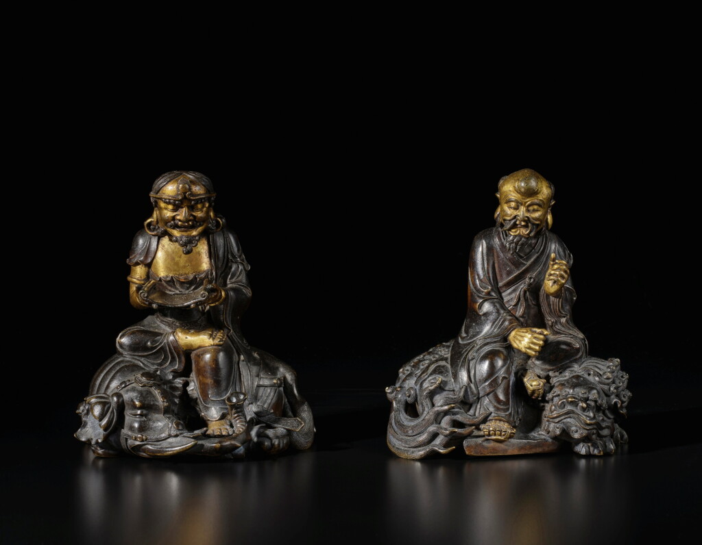 View full screen - View 1 of Lot 663. A rare pair of dated and inscribed parcel-gilt bronze figures of luohan, Qing dynasty, dated Kangxi jiawu year, corresponding to 1714 | 清康熙五十三年(1714) 銅局部鎏金騎象羅漢及笑獅羅漢.