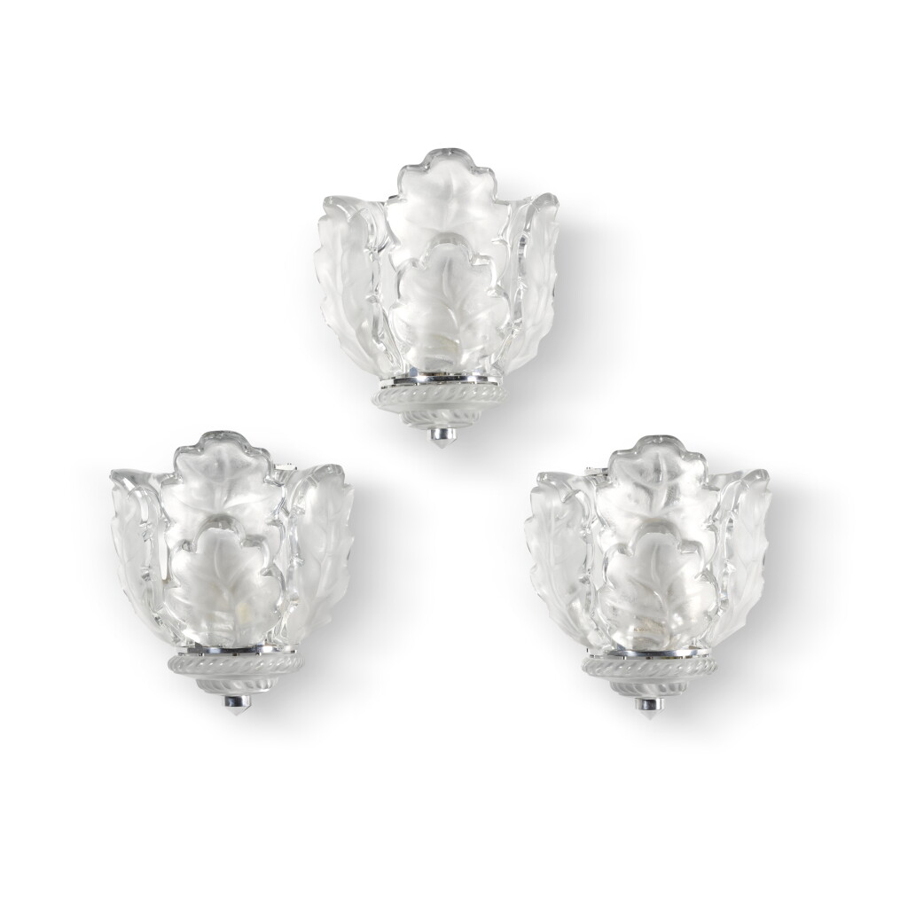 View full screen - View 1 of Lot 522. A set of three Lalique 'Chêne' etched glass and chrome wall sconces, late 20th century to a design from 1951.