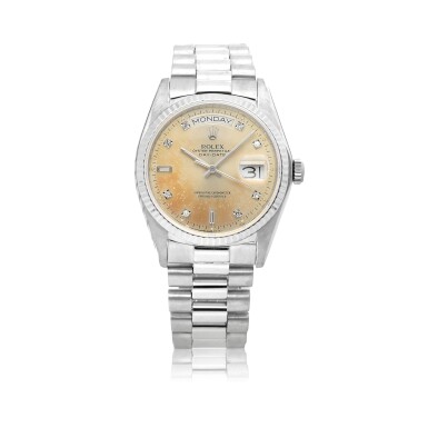 View full screen - View 1 of Lot 201. ROLEX | DAY-DATE, REF 18039, WHITE GOLD AND DIAMOND-SET WRISTWATCH WITH DAY, DATE AND BRACELET, CIRCA 1982.