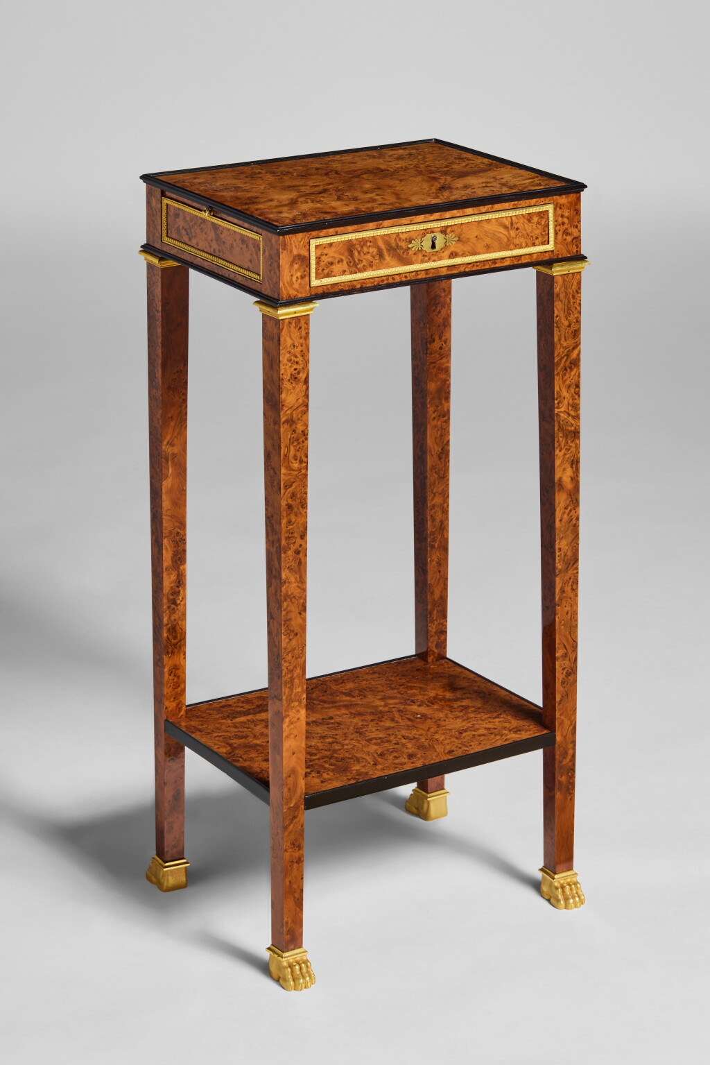View full screen - View 1 of Lot 395. A Consulat Gilt Bronze Mounted and Brass-Inlaid Burr Yew and Ebonized Fruitwood Occasional Table attributed to Martin-Guillaume Biennais, Circa 1800.