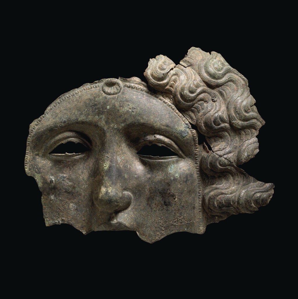 Voir en plein écran - Voir 1 du lot 20. A FRAGMENTARY ROMAN BRONZE CAVALRY PARADE HELMET MASK, CIRCA LATE 2ND CENTURY A.D..