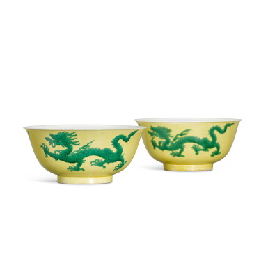 View full screen - View 1 of Lot 1. A rare matched pair of yellow-ground green-enamelled 'dragon' bowls, Marks and period of Kangxi.