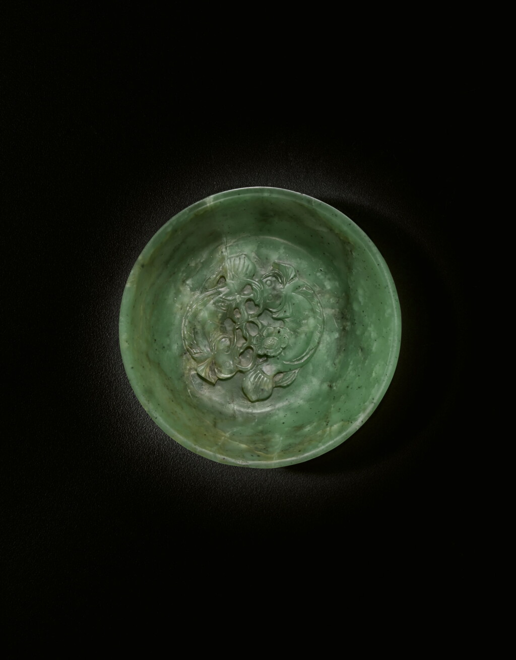 View full screen - View 1 of Lot 456. A spinach-green jade 'twin fish' bowl, Qing dynasty, 18th / 19th century | 清十八 / 十九世紀 碧玉雕年年有餘紋洗.