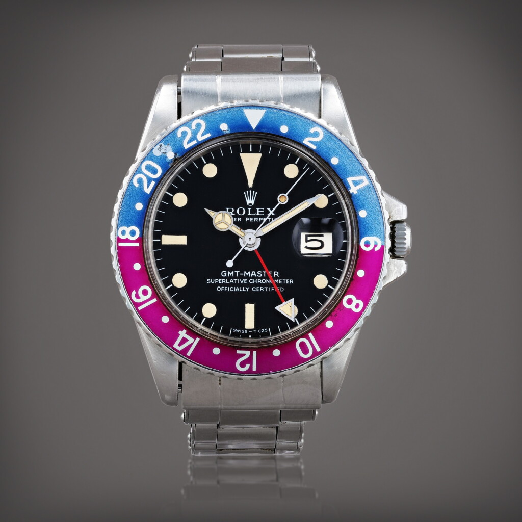 View full screen - View 1 of Lot 416. GMT-Master 'Fuschia bezel and Long E dial', reference 1675 Montre bracelet à double fuseau horaire en acier avec date | Stainless steel dual time zone wristwatch with date and bracelet Vers 1968 | Circa 1968.