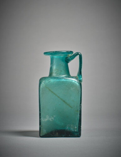 View full screen - View 1 of Lot 602. A Gallo-Roman Green Glass Jug, circa 2nd Century A.D..