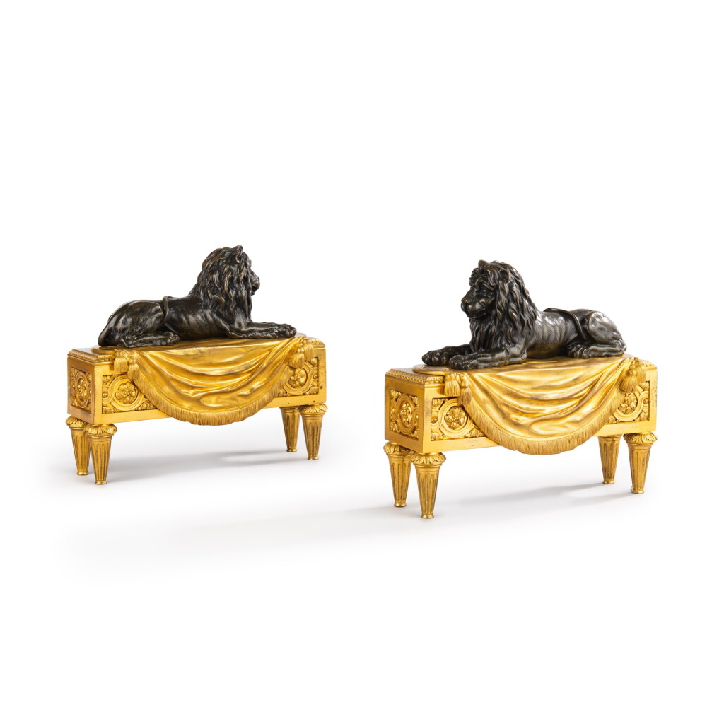 View full screen - View 1 of Lot 558. A pair of patinated and gilt-bronze chenets aux lions, late Louis XVI - early 19th century, attributed to Pierre-Phillippe Thomire.