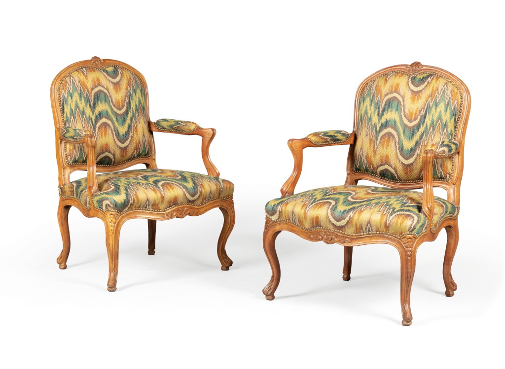 View full screen - View 1 of Lot 8. A pair of Louis XV carved beechwood fauteuils, mid-18th century | Paire de fauteuils en hêtre d'époque Louis XV, milieu du XVIIIème siècle.