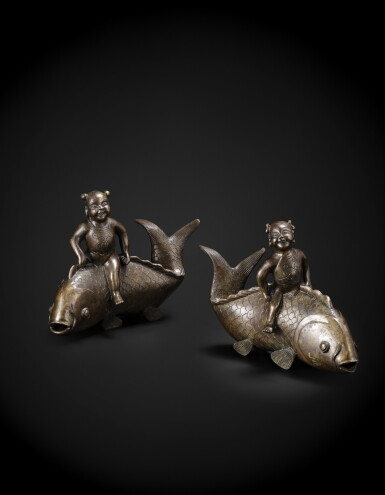 View full screen - View 1 of Lot 226. A pair of bronze 'carp and children' group Qing dynasty, 18th-19th century | 清十八至十九世紀 銅童子騎魚擺件一對.
