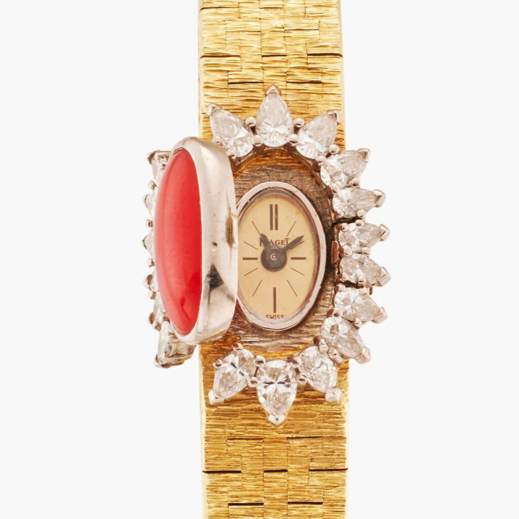 View full screen - View 1 of Lot 127. Reference 1428 A 6 | A yellow gold, diamond, and coral-set concealed dial bracelet watch, Circa 1969.