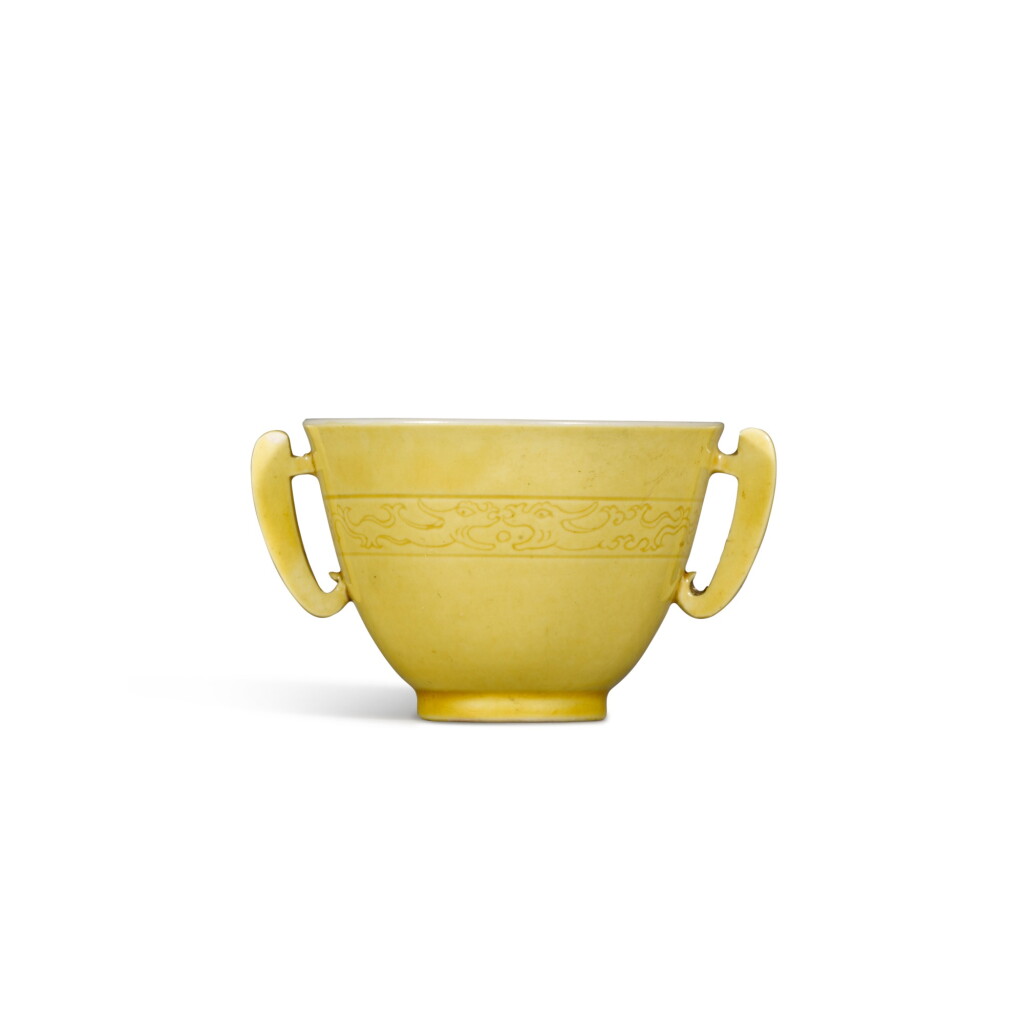 View full screen - View 1 of Lot 1. A yellow-glazed handled cup, Mark and period of Kangxi | 清康熙 黃釉暗刻龍紋耳盃 《大清康熙年製》款 .
