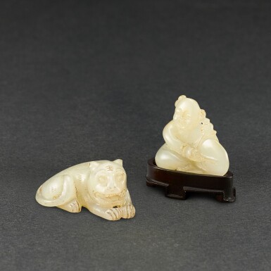 View full screen - View 1 of Lot 564. A WHITE JADE FIGURE OF A TIGER AND A WHITE JADE 'BOY AND DRUM' GROUP QING DYNASTY | 清 白玉臥虎及擊鼓童子一組兩件.