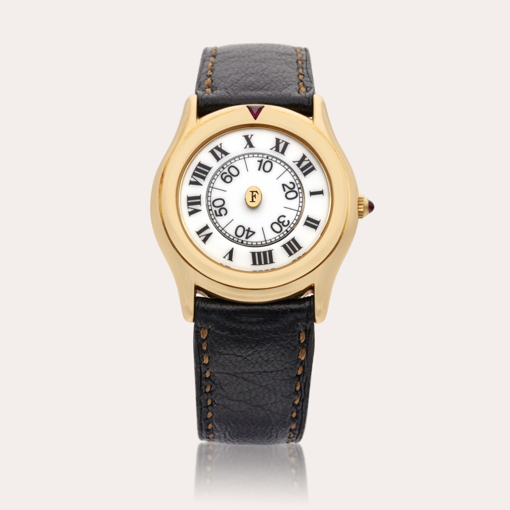 View full screen - View 1 of Lot 448. Pharos | A yellow gold wristwatch with rotating dial, Circa 1980s.