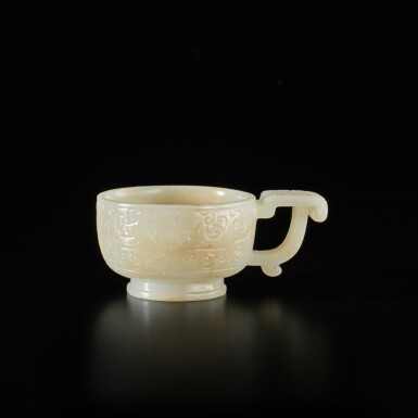 View full screen - View 1 of Lot 834. A small archaistic white jade 'taotie' vessel, Late Ming dynasty | 明末 白玉饕餮紋匜.