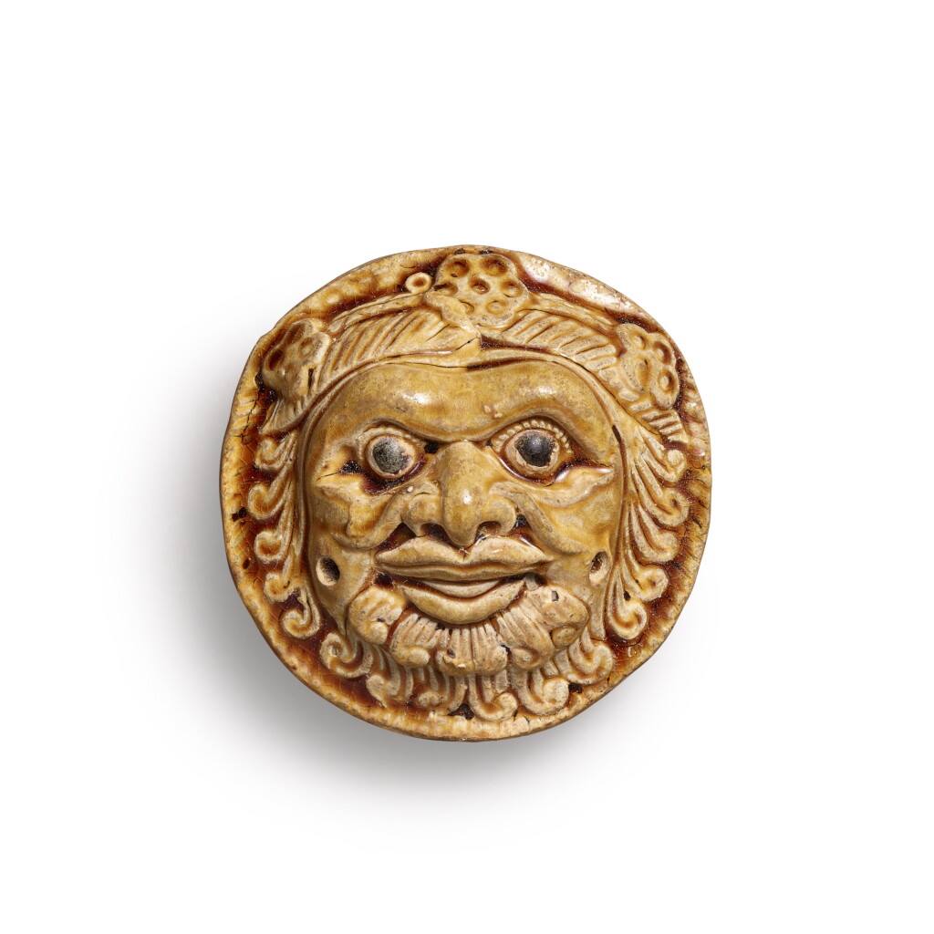 View full screen - View 1 of Lot 1077. A yellow-glazed 'foreigner' whistle, Northern Qi dynasty | 北齊 黃釉胡人面塤.