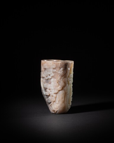 View full screen - View 1 of Lot 209. A pale jade 'pine trunk' rhyton, Qing dynasty, Qianlong period | 清乾隆 清白玉蒼松紋首盃.