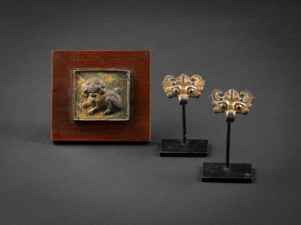 View full screen - View 1 of Lot 113. A gilt-bronze 'lion' belt plaque and two 'taotie' ornaments, Tang dynasty.