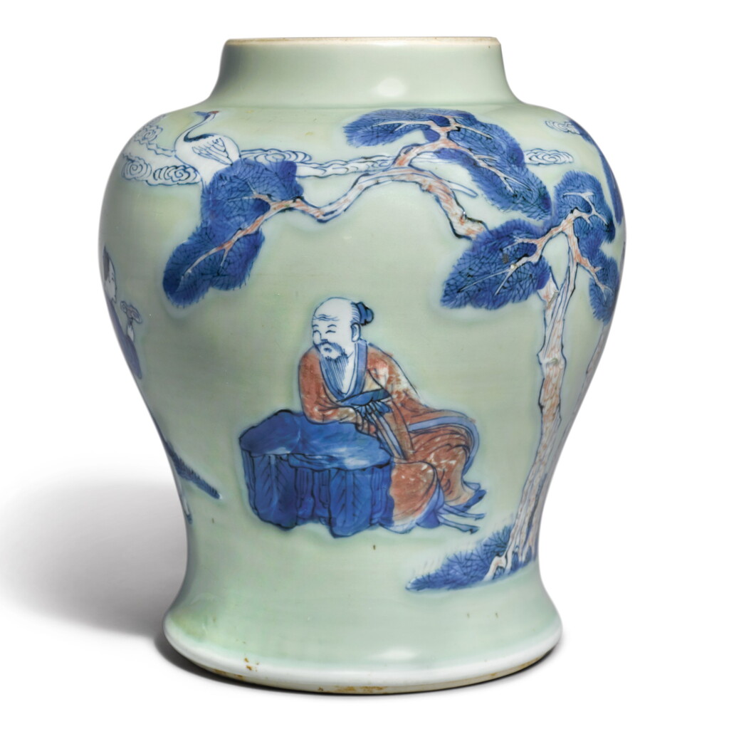 View full screen - View 1 of Lot 143. An underglaze-blue, copper-red, and celadon-glazed jar, Qing dynasty, Kangxi period | 清康熙 豆青地青花釉裏紅松下高士圖罐.