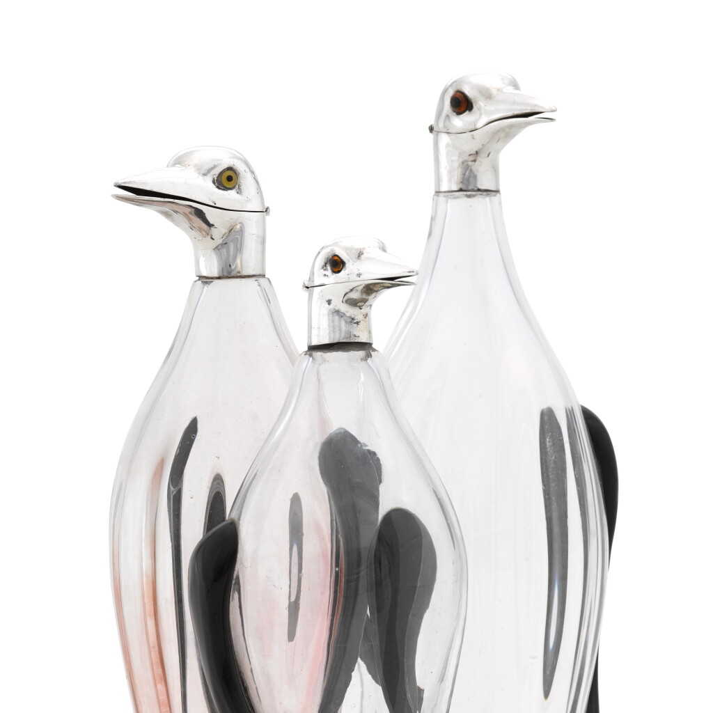 View full screen - View 1 of Lot 68. A highly unusual graduated suite of silver-mounted penguin decanters, Asprey & Co. Ltd., London, 1957-1959.