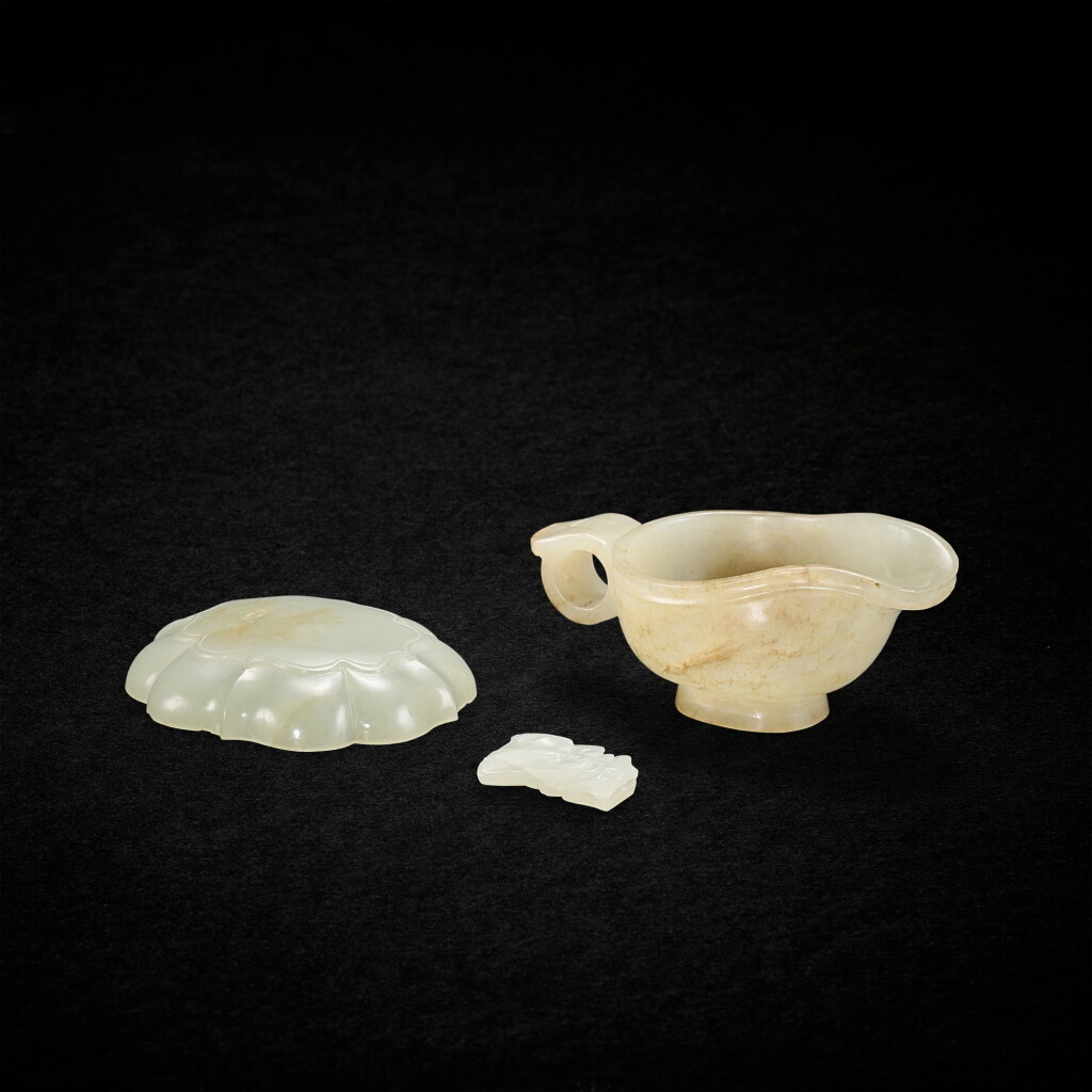 View full screen - View 1 of Lot 5651. A celadon jade lobed box cover, a celadon jade archaistic ewer, yi, and a white jade 'dragon' ornament, Ming - Qing dynasty 明至清 青玉葵口盒蓋、青玉仿古匜及白玉龍首飾一組三件.