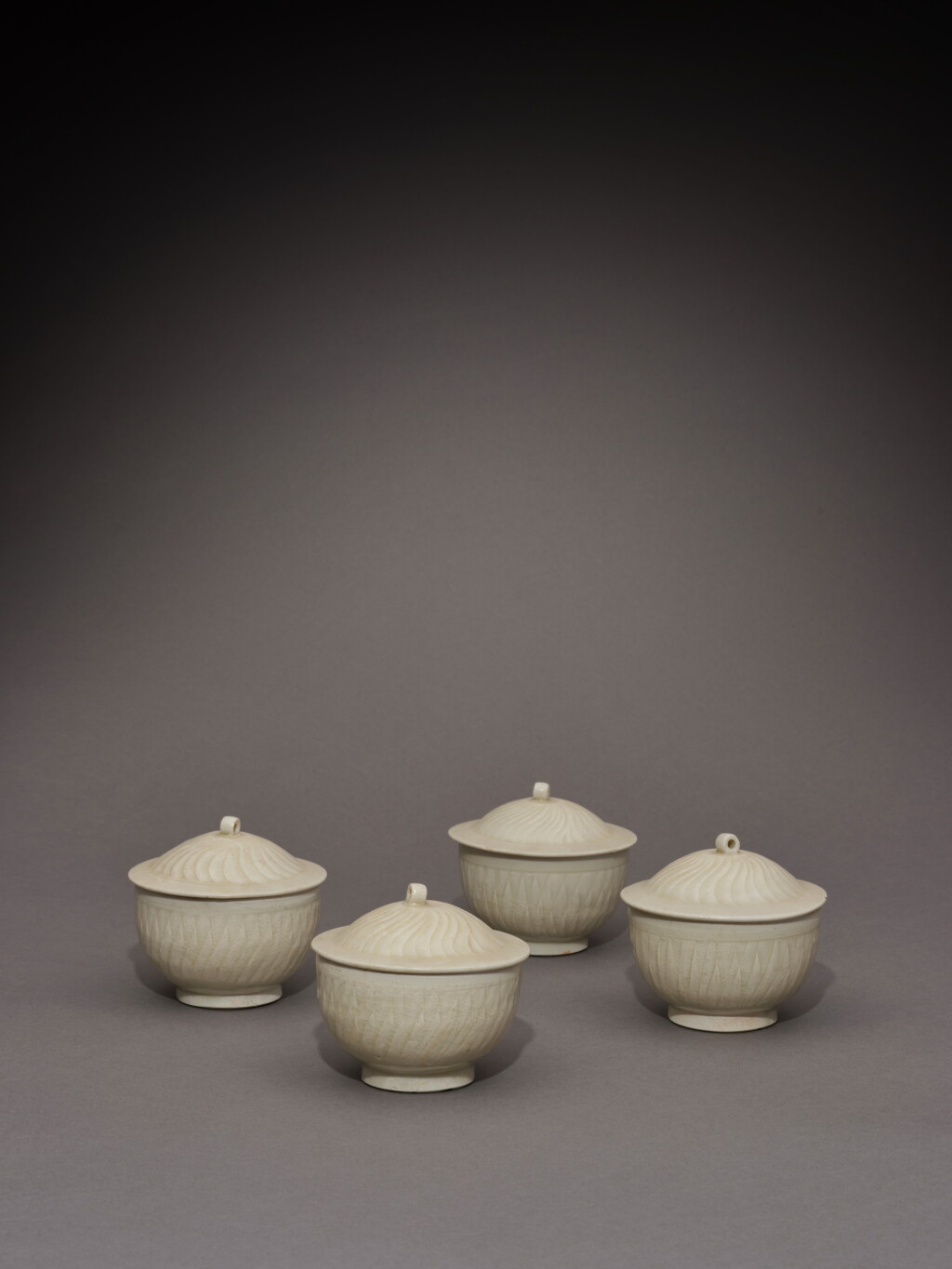 View full screen - View 1 of Lot 81. A rare group of four Qingbai white-glazed bowls and covers, Song dynasty | 宋 白釉蓋盌 一組四件.