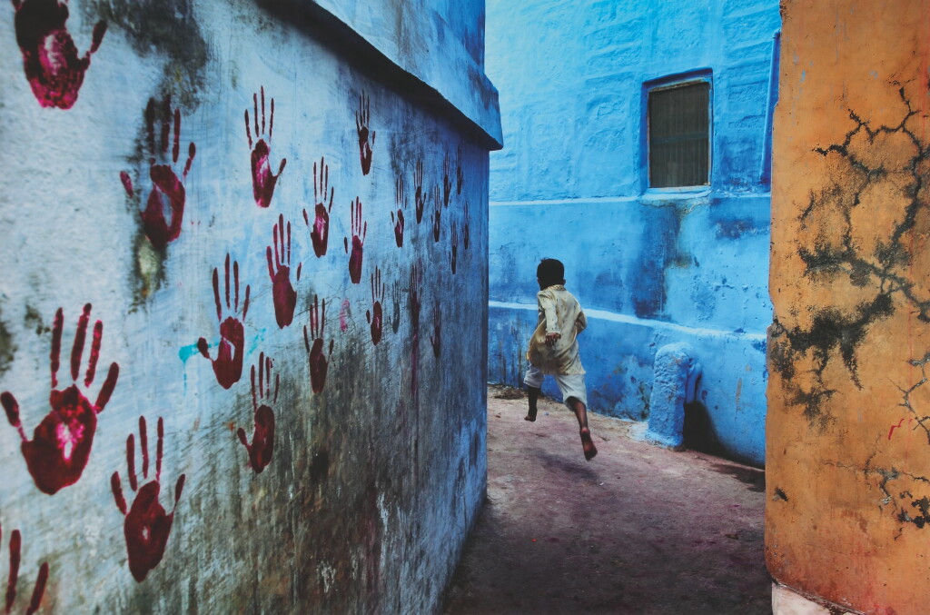 View full screen - View 1 of Lot 198. STEVE MCCURRY | BOY IN MID-FLIGHT, JODHPUR, INDIA.