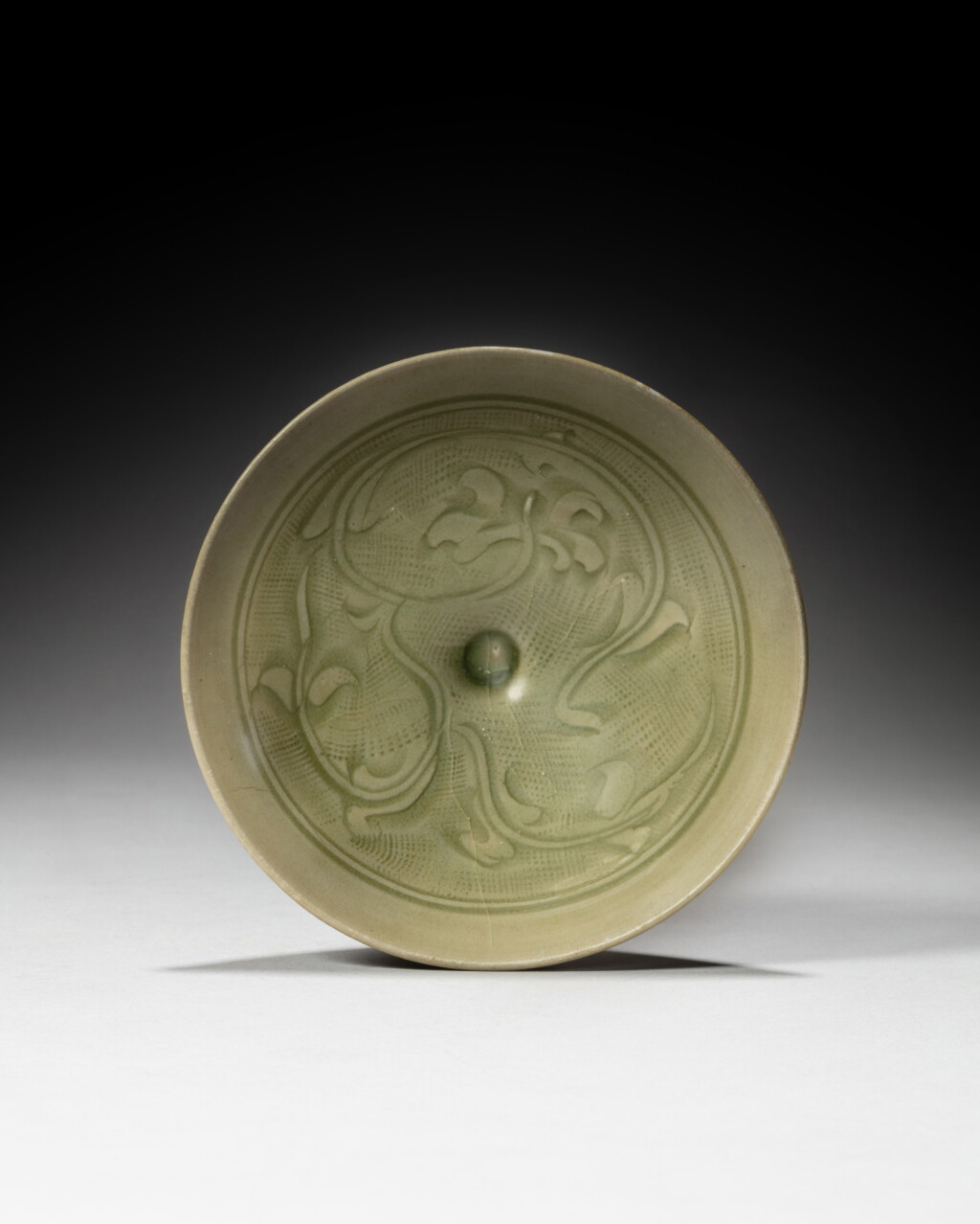 View full screen - View 1 of Lot 117. A carved 'Tongan' celadon-glazed 'floral' bowl, Song dynasty | 宋 同安窰青釉刻花卉紋盌.
