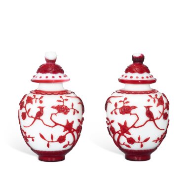 View full screen - View 1 of Lot 557. A pair of red overlay glass 'prunus and magpie' jars and covers, Qing dynasty, 19th century 清十九世紀 涅白地套紅料喜上眉梢蓋罐一對 《乾隆年製》仿款.