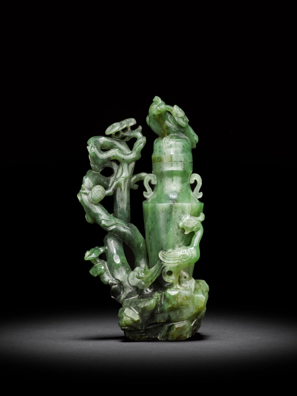 View full screen - View 1 of Lot 26. An archaistic spinach-green jade 'phoenix' vase and cover, Qing dynasty, 18th century | 清十八世紀 碧玉仿古鳳紋蓋瓶.