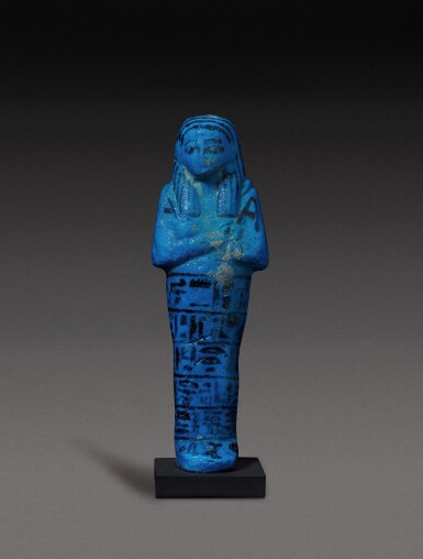 View full screen - View 1 of Lot 145. An Egyptian Brilliant Blue Faience Ushabti of Nesi-Khonsu, Principal Wife of the High Priest of Amun, Pinudjem II, 21st Dynasty, 1075-944 B.C.
