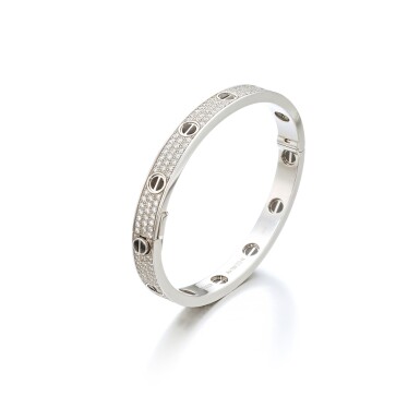 View full screen - View 1 of Lot 718. Gold, diamond and ceramic bangle, ‘Love’.