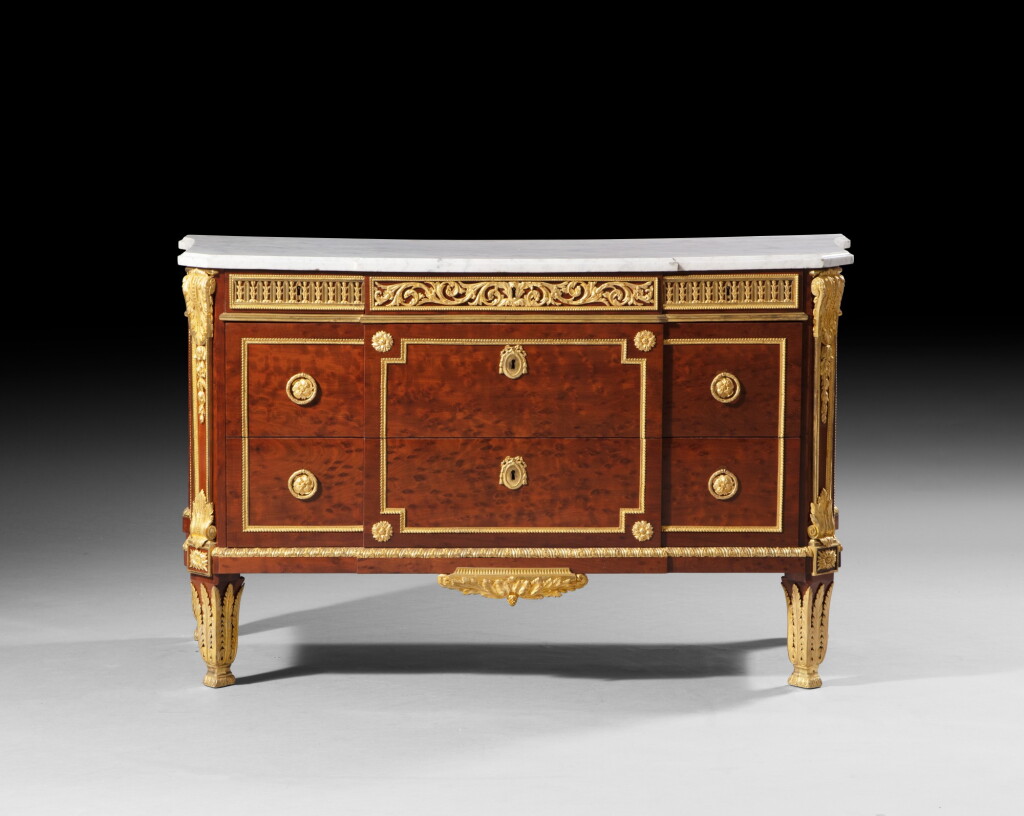 View full screen - View 1 of Lot 127. A Louis XVI gilt-bronze-mounted plum-pudding mahogany commode, circa 1783, stamped 'J. H RIESENER' | Commode en acajou moucheté et bronze doré d'époque Louis XVI, vers 1783, estampillée "J. H RIESENER".