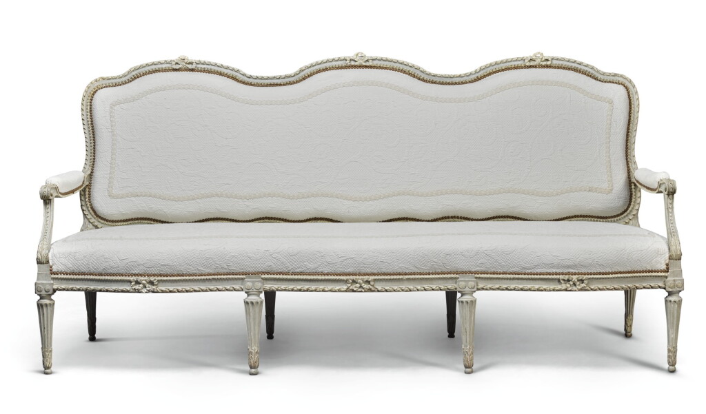 View full screen - View 1 of Lot 42. A LOUIS XVI CARVED GREY PAINTED CANAPÉ, BY LOUIS-CHARLES CARPENTIER, CIRCA 1775.