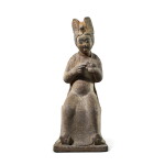 A rare large limestone figure of a seated lady feeding a bird, Tang dynasty | 唐 石灰岩雕持鳥仕女坐像