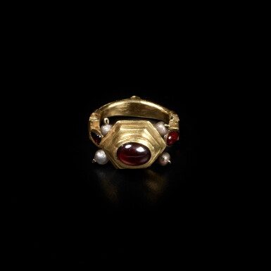 View full screen - View 1 of Lot 256. A Hellenistic Gold and Garnet Finger Ring, circa 2nd Century B.C..