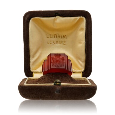 View full screen - View 1 of Lot 104. A carnelian seal ring carved with the arms of the Egyptian Royal Family.