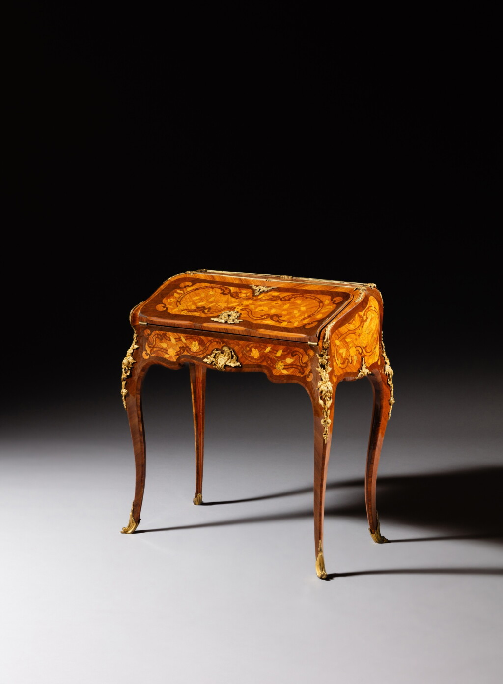 View full screen - View 1 of Lot 35. A Louis XV gilt-bronze mounted amaranth veneered, tulipwood, maple and holly marquetry bureau de pente, stamped by BVRB, the bronzes with a crowned ‘C’, circa 1745.