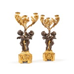 A pair of Louis XVI style patinated and gilt-bronze three-light candelabra, first half of 19th century | Paire de candélabres à trois lumières en bronze doré et patiné de style Louis XVI, première moitié du XIXe siècle