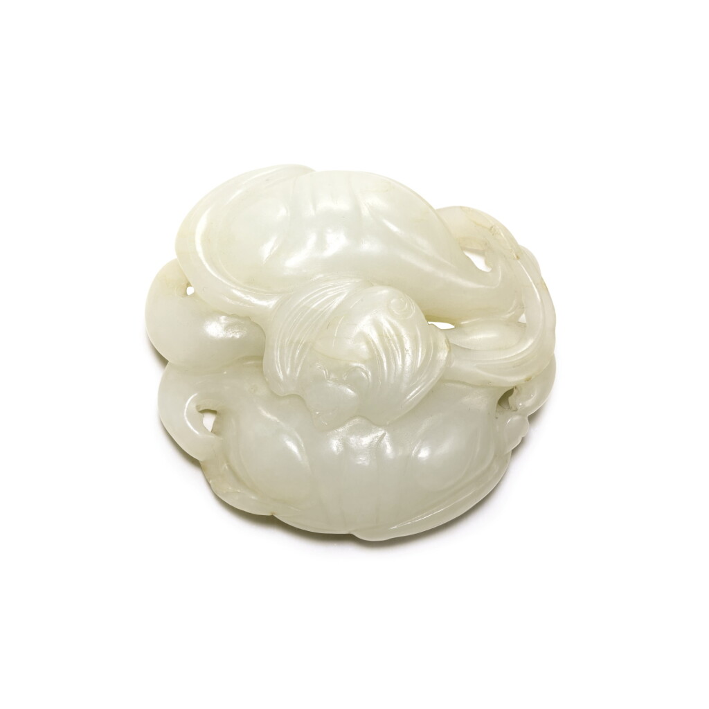 View full screen - View 1 of Lot 250. A BLACK AND WHITE JADE 'LOTUS AND BAT' GROUP, QING DYNASTY, 19TH CENTURY | 清十九世紀 白玉福至心靈紋把件.