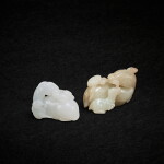 A celadon jade 'ram and lingzhi' group and a white jade 'three rams' group, Qing dynasty, 18th - 19th century 清十八至十九世紀 青白玉羊銜靈芝 及 白玉三陽開泰