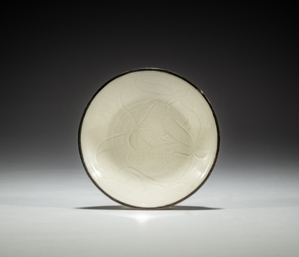 View full screen - View 1 of Lot 54. A carved 'Ding' 'lotus' dish, Northern Song dynasty | 北宋 定窰白釉刻蓮花紋盤.