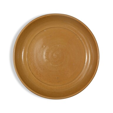 View full screen - View 1 of Lot 669. A large molded 'Longquan' dish, Ming dynasty | 明 龍泉窰印花大盤.