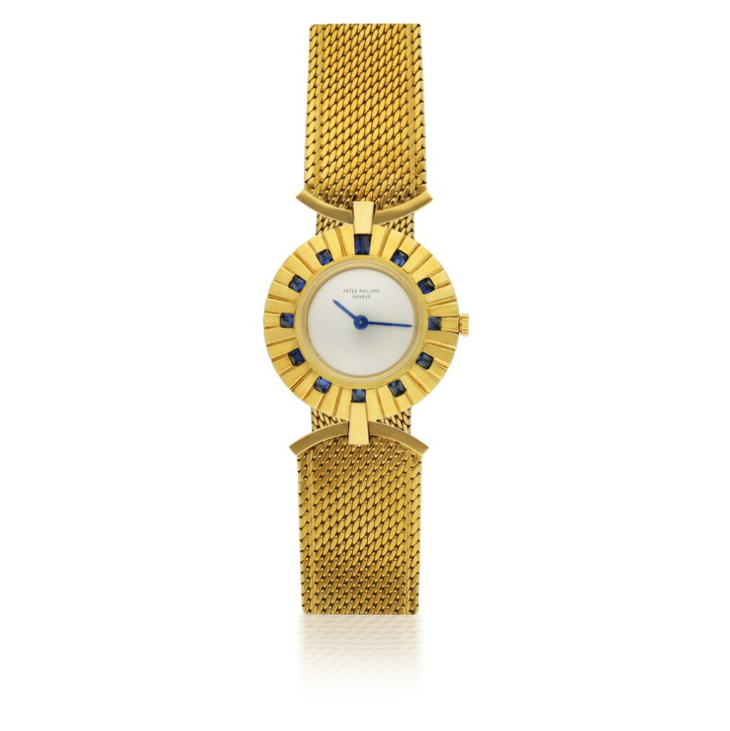 View full screen - View 1 of Lot 120. PATEK PHILIPPE | REF 3453, A YELLOW GOLD AND SAPPHIRE-SET BRACELET WATCH CIRCA 1945.