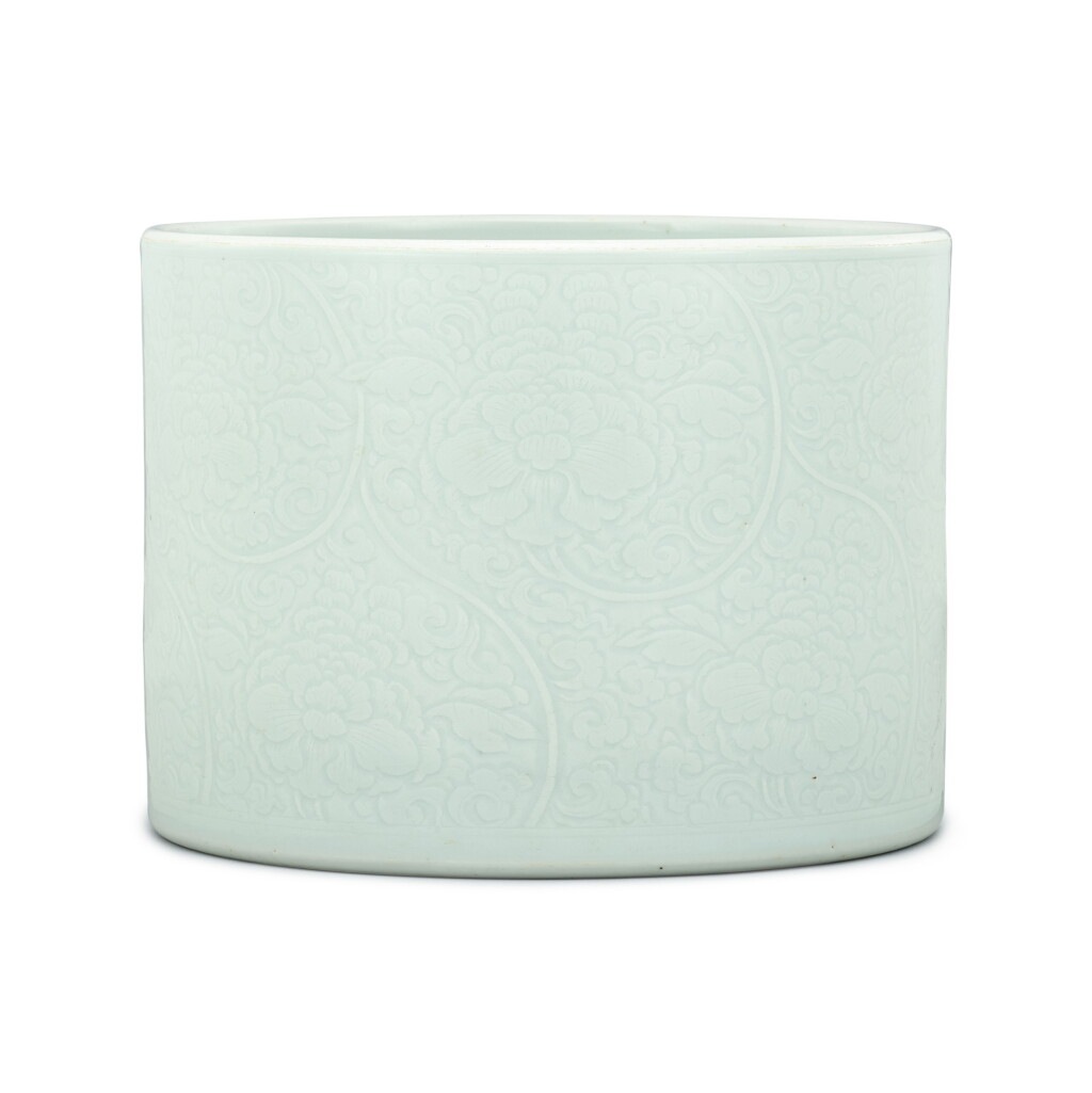 View full screen - View 1 of Lot 308. A large celadon-glazed carved 'peony' brushpot Qing dynasty, 18th century | 清十八世紀 淺青釉刻纏枝牡丹紋筆筒.