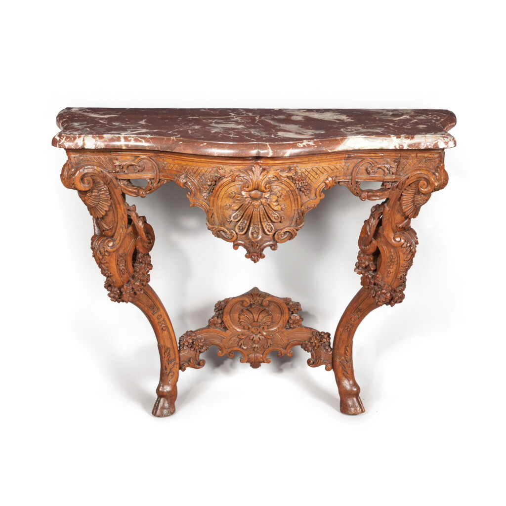 View full screen - View 1 of Lot 46. A rococo carved walnut console, German, probably Würzburg, mid 18th century | Console rococo en noyer sculpté, Allemagne, probablement Würzbourg, milieu du XVIIIeme siècle.