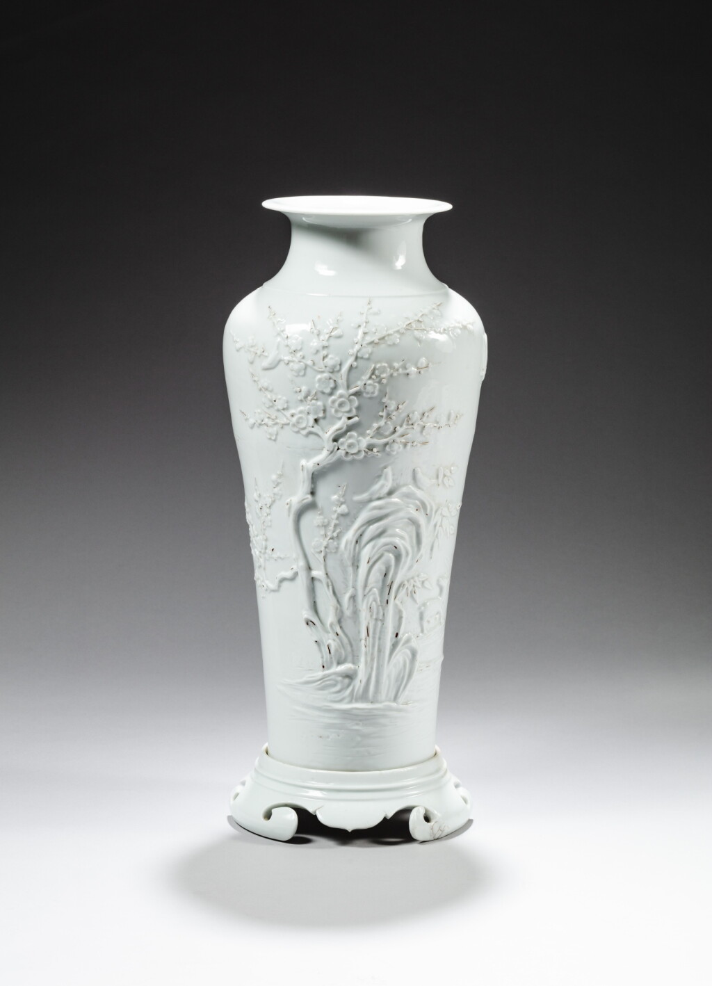 View full screen - View 1 of Lot 157. A white-glazed 'prunus' vase and stand, Qing dynasty, Kangxi period | 清康熙 白釉梅紋梅瓶.