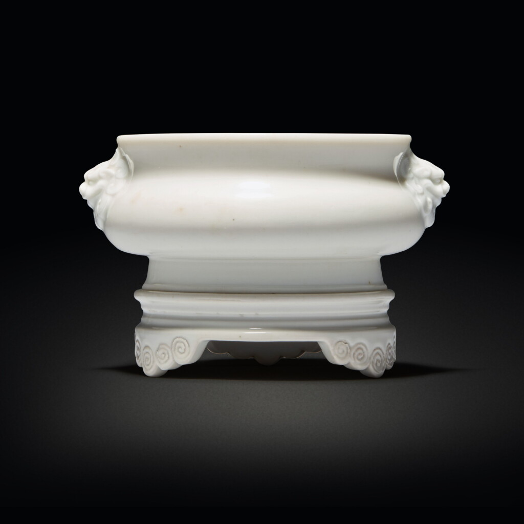 View full screen - View 1 of Lot 571. A 'Dehua' bombe-form censer and tripod stand, Qing dynasty, 17th / early 18th century | 清十七 / 十八世紀初 德化白釉鋪首耳爐連座 《大明宣德年製》仿款.