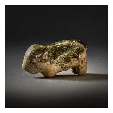 View full screen - View 1 of Lot 250. A RARE DARK GREEN STONE CARVING OF A RAM, NEOLITHIC PERIOD.